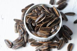 Sunflower seeds toasted in a blue bucket photo