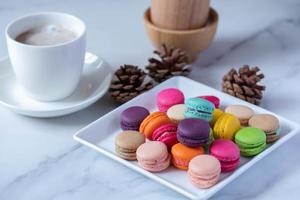 colorful macarons in white plate photo