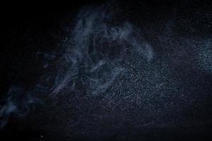 incense and smoke on black background photo