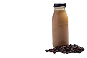 Coffee flavored milk in a glass bottle on a white background.