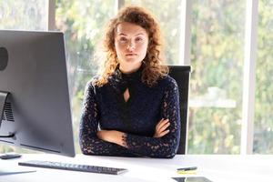 Attractive beautiful and confident business woman working with computer in the modern office or home photo