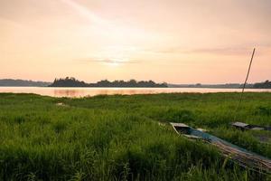 Landscape of Small Creek with Meadow and Fishing Boat photo