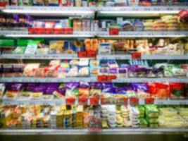 Blurred of product shelves in supermarket or grocery store, use as background photo