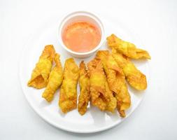 Deep Fried Won ton on white plate with dip source photo