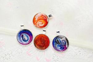 Create galaxy drink coasters using resin, glitter and pigment powders, handmade items. Suitable for keychains, necklace and pendant. photo