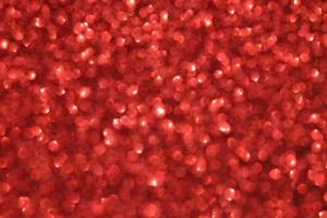 Red sparkle blurry background with glittering white dots texture photo