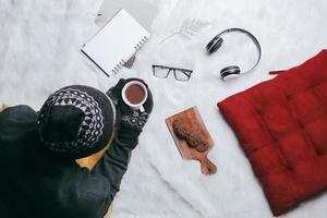 Man enjoying winter season with hot chocolate and cookies photo