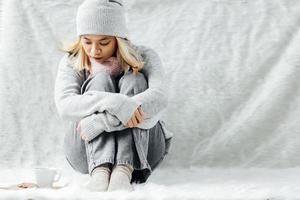 A blonde girl feeling lonely on winter photo