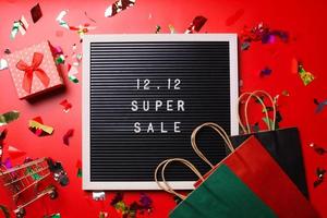 12.12 Shopping day super sale flat lay concept on red background photo