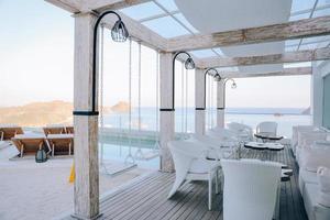 configuración de mesa y sillas de restaurante en el comedor con vista al mar foto