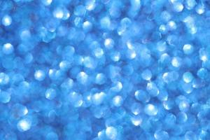 Blue sparkle blurry background with blurred and shiny dots texture photo