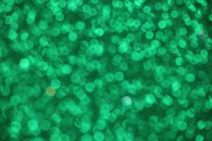 Green sparkle blurry background with fuzzy dots texture photo
