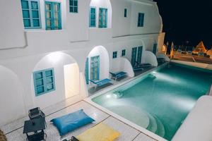 Top view of swimming pool in the middle of art deco resort building at night. Labuan bajo, Indonesia, August 2021