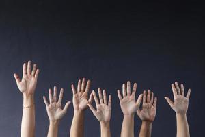 Hands raising on grey background photo