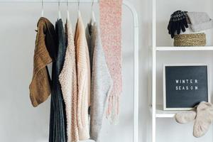 Winter clothes and accessories on hanger photo