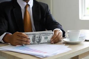 Corruption and bribery, Businessman receiving money on his office desk photo