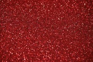 Red sparkle blurry background with glittering white dots texture photo