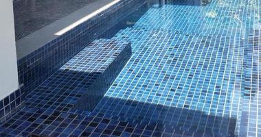 clear water in the swimming pool is covered with mosaics photo