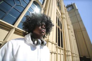 Afro American man having fun walking in city center - Happy young guy enjoying time a sunset outdoor - Millennial generation lifestyle and positive people attitude concept photo