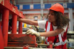 Female worker Foreman or worker work at factory site check up machine or products in site. Engineer or Technician checking Material or Machine on Plant. Industrial and Factory. photo