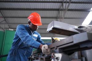 Maintenance Engineers is working in front of the automated CNC machinery repair on a maintenance checklist at the production line. photo