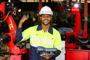 industrial factory employee working with machine part, checking and testing industrial equipment and robot arms in large Electric electronics wire and cable manufacturing plant factory photo