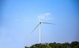 The wind turbine power working, blue sky, energy power concept photo