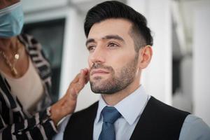 portrait of handsome man was make up by artist on his face. photo