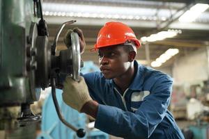 Maintenance Engineers is working in front of the automated CNC machinery repair on a maintenance checklist at the production line. photo