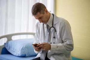 Doctor With Arms Crossed Holding Stethoscope photo