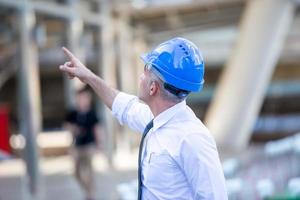 Architect of construction engineer working in construction site and management in the construction site photo