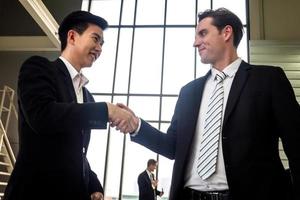 Businessman handshake for teamwork of business merger and acquisition,successful negotiate,hand shake,two businessman shake hand with partner to celebration partnership and business deal concept photo