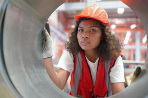 Female worker Foreman or worker work at factory site check up machine or products in site. Engineer or Technician checking Material or Machine on Plant. Industrial and Factory. photo