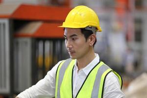 Industry worker Foreman or worker work at factory site check up machine or products in site. Engineer or Technician checking Material or Machine on Plant. Industrial and Factory. photo