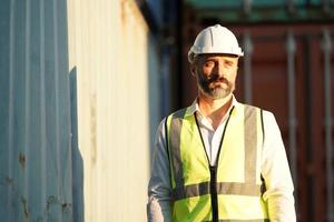 Foreman checking containers in the terminal, at import and export business logistic company. photo