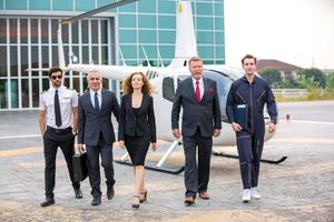 Successful business people standing together widen out showing strong relationship of worker community. A team of businessman and businesswoman expressing a strong group teamwork at the modern office. photo