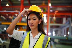 Female worker Foreman or worker work at factory site check up machine or products in site. Engineer or Technician checking Material or Machine on Plant. Industrial and Factory. photo