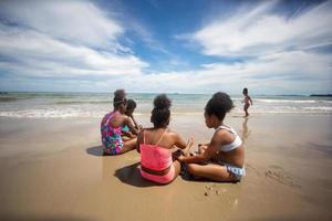 Kids playing running on sand at the beach photo