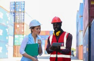 Foreman checking containers in the terminal, at import and export business logistic company. photo