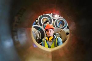 Industry worker Foreman or worker work at factory site check up machine or products in site. Engineer or Technician checking Material or Machine on Plant. Industrial and Factory. photo
