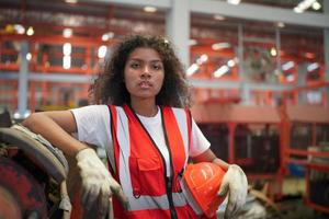 Female worker Foreman or worker work at factory site check up machine or products in site. Engineer or Technician checking Material or Machine on Plant. Industrial and Factory. photo