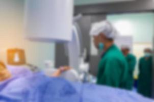 Blurred background of modern operating room at hospital with Group of surgeons in operating room with surgery equipment. Modern medical background photo