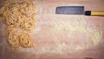 aerial view of cutting board with fresh pasta and flour