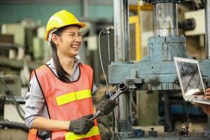 Female Worker work at factory site check up machine in products line or products in site. Engineer or Technician checking Material or Machine on Plant. Industrial and Factory. photo