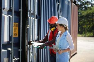 Foreman checking containers in the terminal, at import and export business logistic company. photo