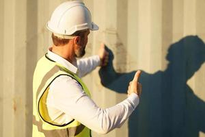 Foreman checking containers in the terminal, at import and export business logistic company. photo