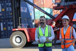 Foreman checking containers in the terminal, at import and export business logistic company. photo