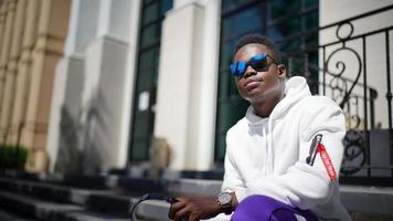 Afro American man having fun walking in city center - Happy young guy enjoying time a sunset outdoor - Millennial generation lifestyle and positive people attitude concept photo