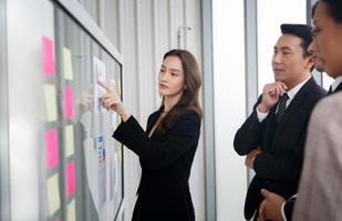 Shot of a group of businesspeople having a question and discussion in an office photo