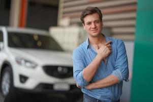 Portrait of handsome man on blue shirt standing at outdoor. photo